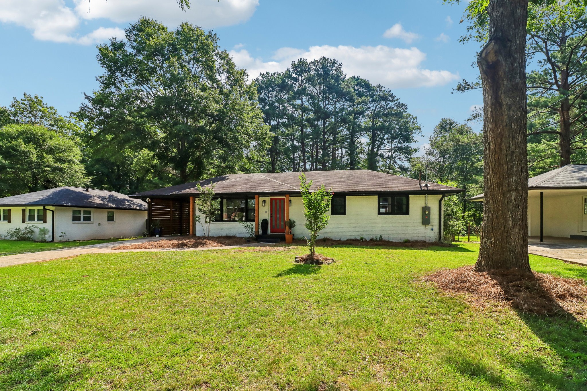 A generous front lawn beneath Decatur’s leafy canopy