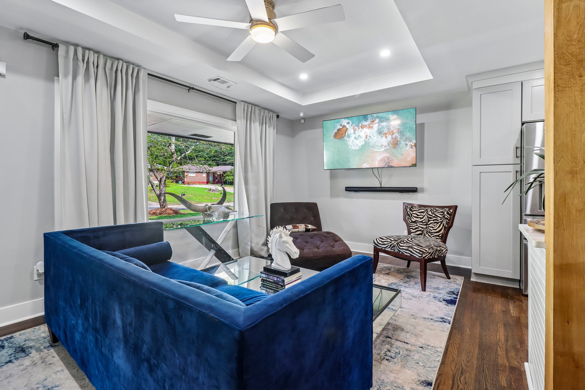 Light-filled living room with a sculptural tray ceiling
