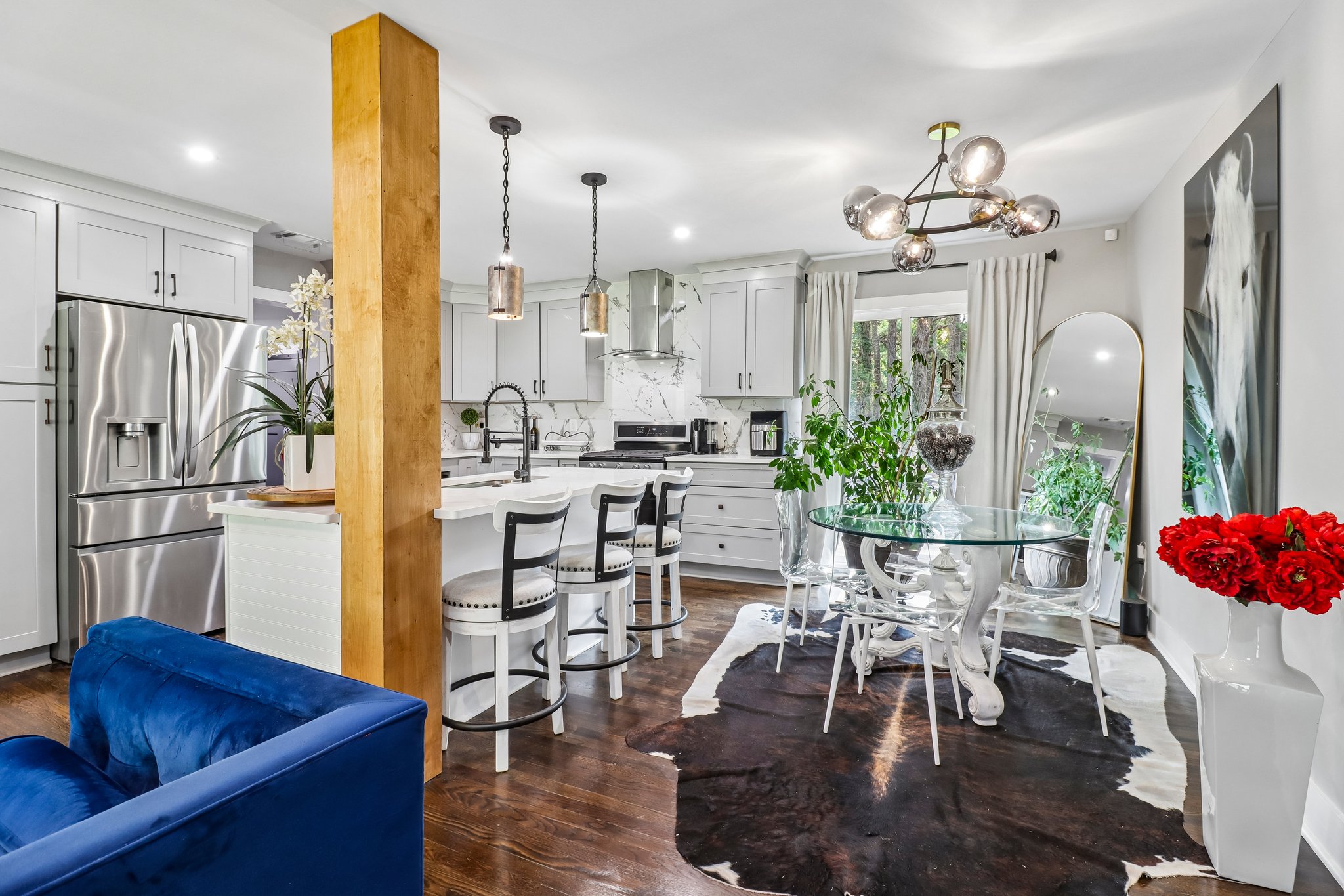Kitchen and dining come together beneath statement lighting