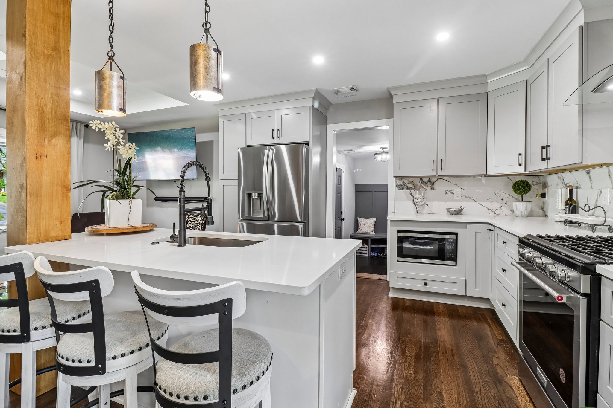 Custom cabinetry surrounds the kitchen with practical elegance
