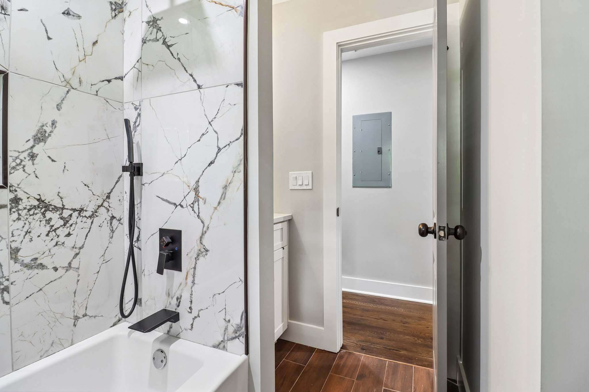 Matte-black fixtures bring striking contrast to the guest bath