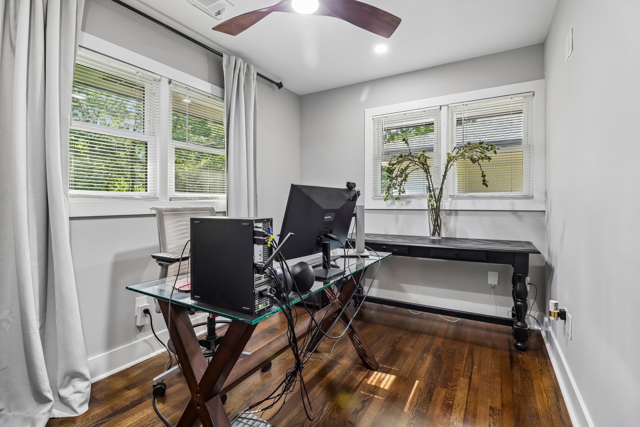 The sunlit third bedroom is currently styled as a creative workspace