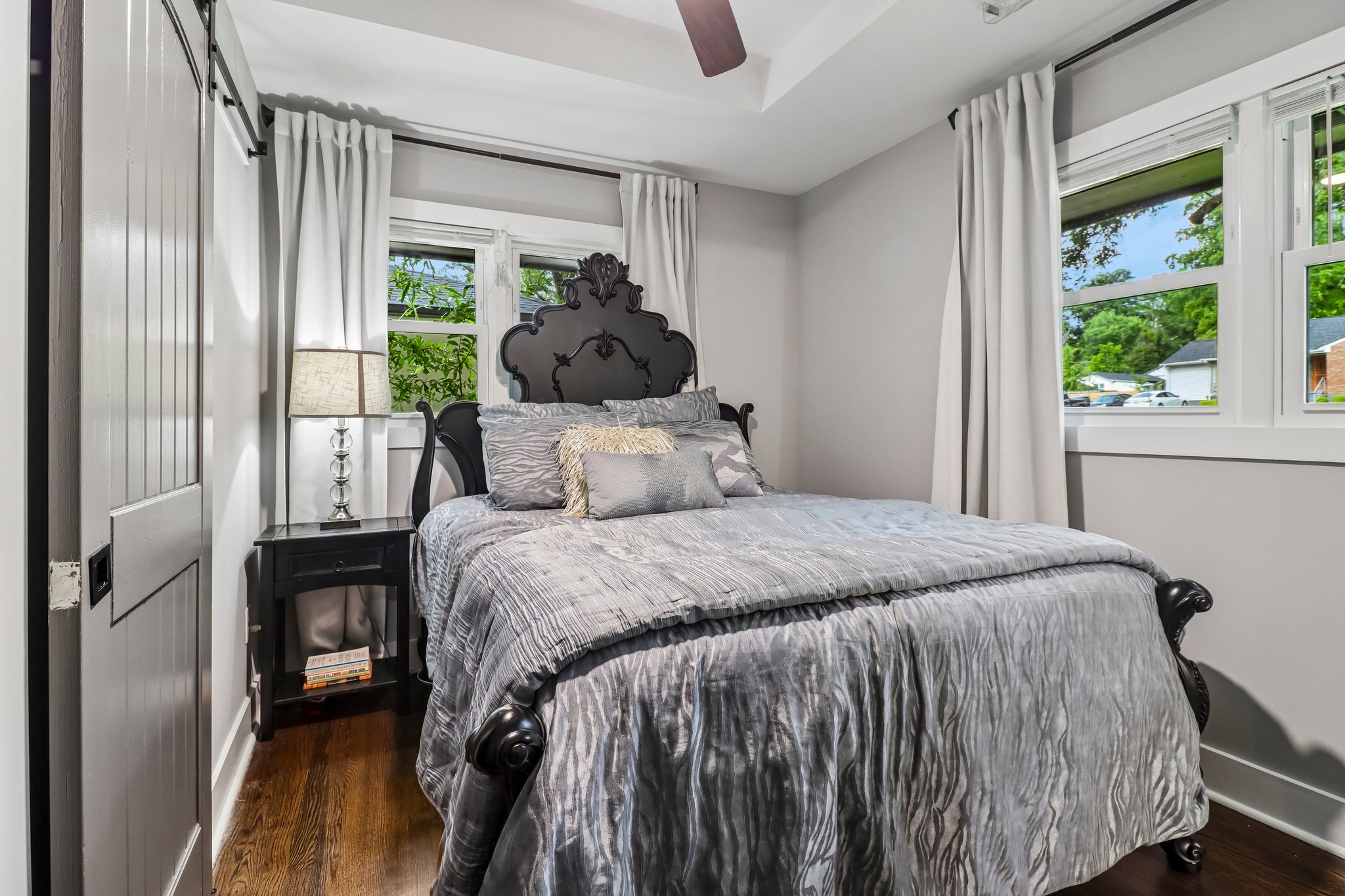 Primary suite pairs ornate furnishings with abundant daylight