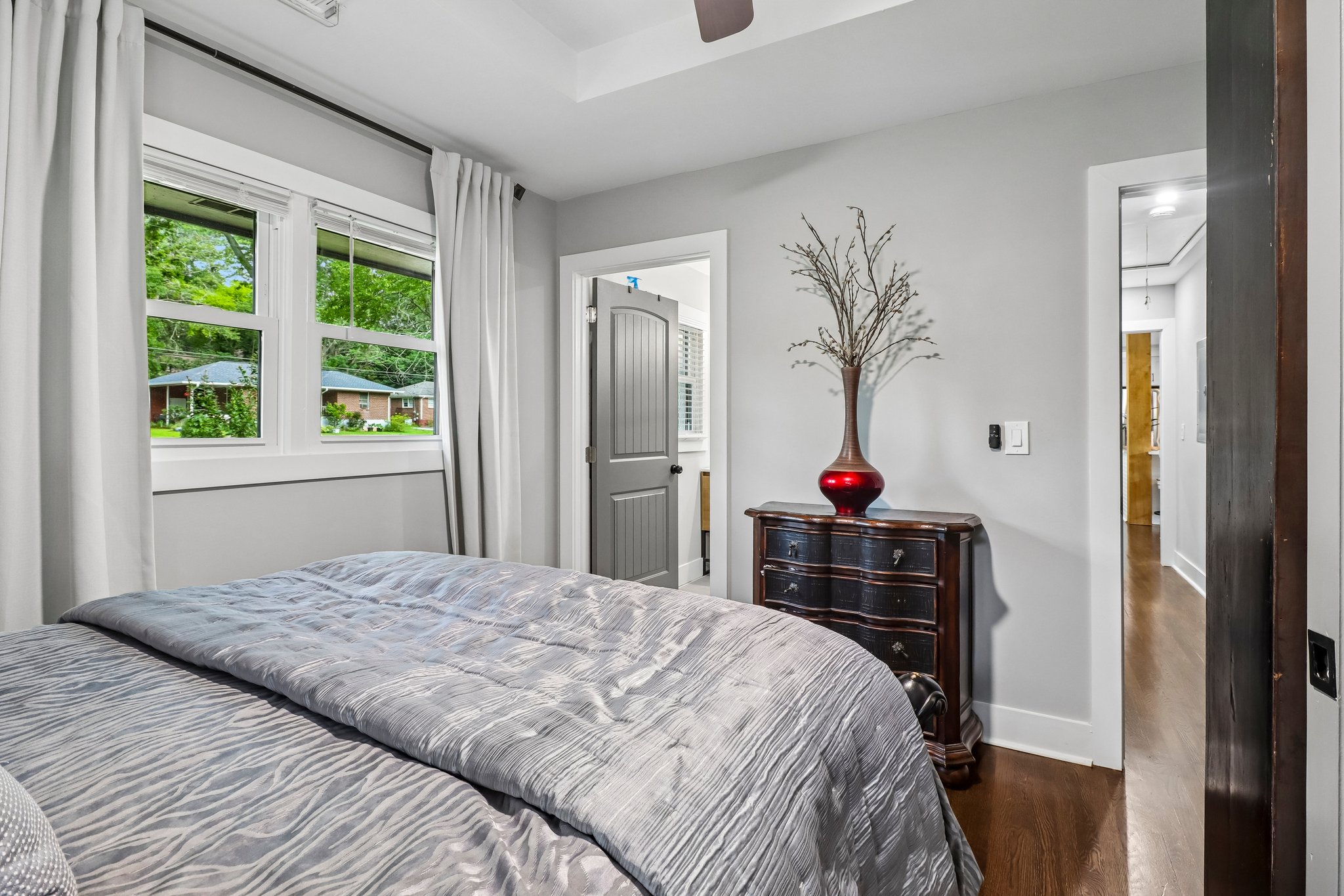The primary suite enjoys leafy views and direct bath access