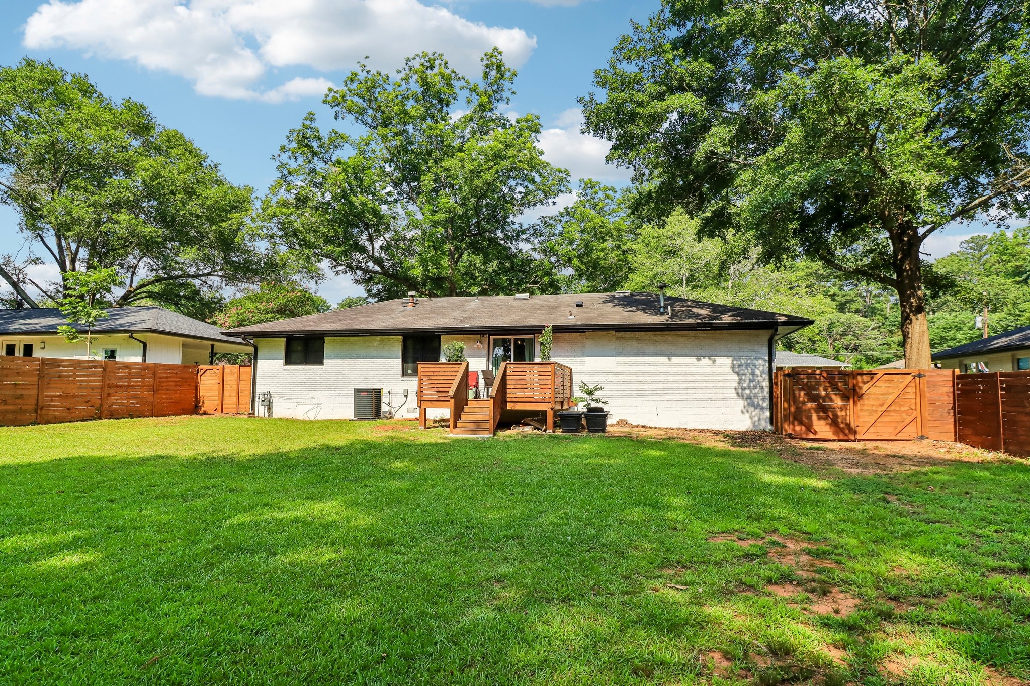 Broad backyard view highlights room to gather, garden and play