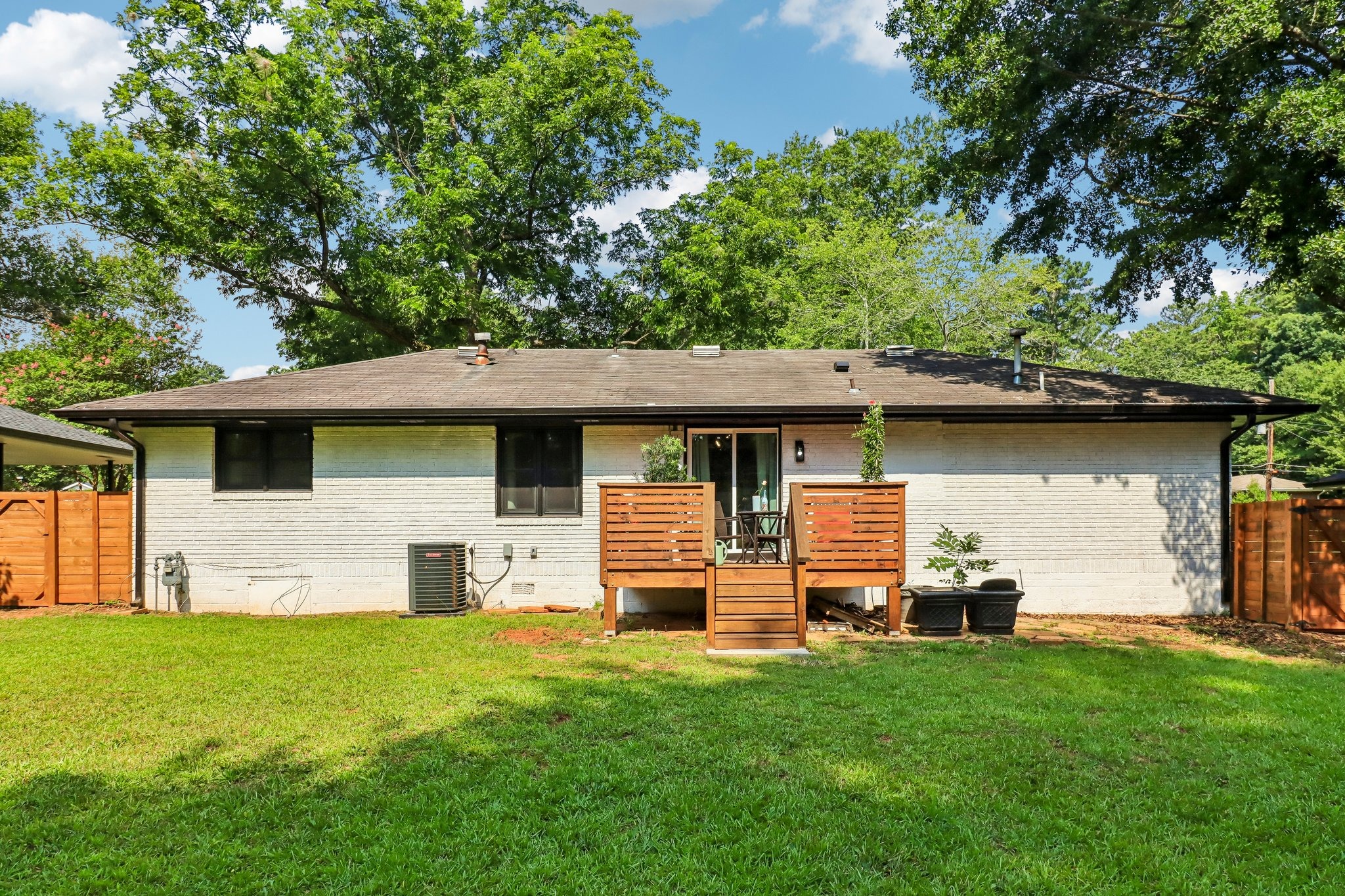 Private rear deck creates a natural bridge from home to yard
