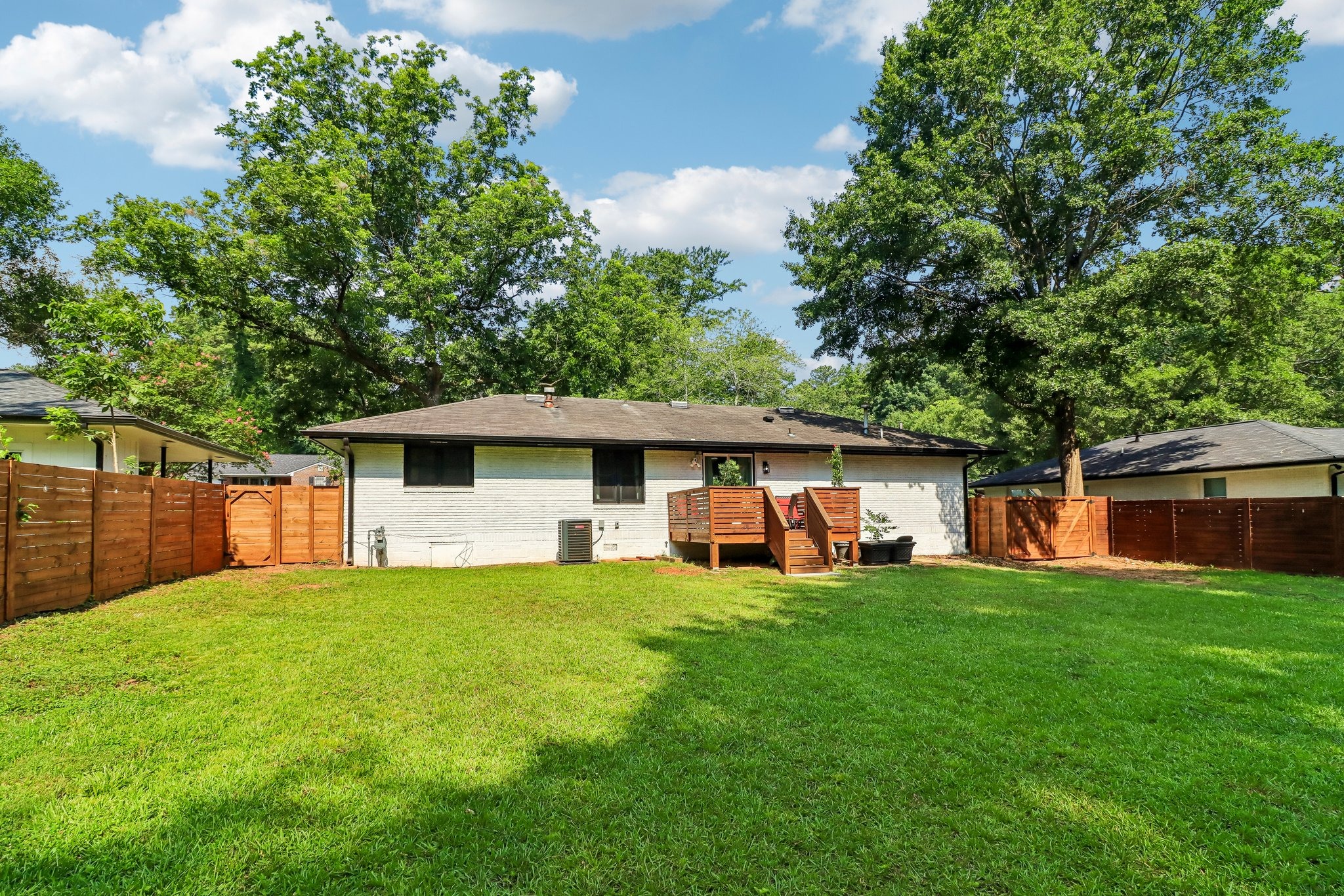 Deep fenced yard offers exceptional breathing room